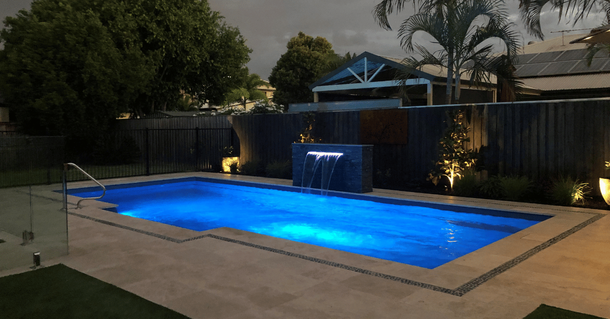 Surface-mounted multi-colour LED light on a Cosmopolitan 9m in Blue Rock fibreglass pool wall