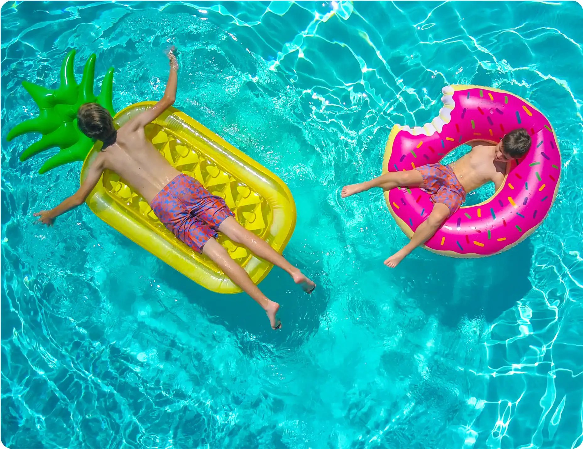 Enjoying a sunny day in the perfect pool on inflatable toys with friends.